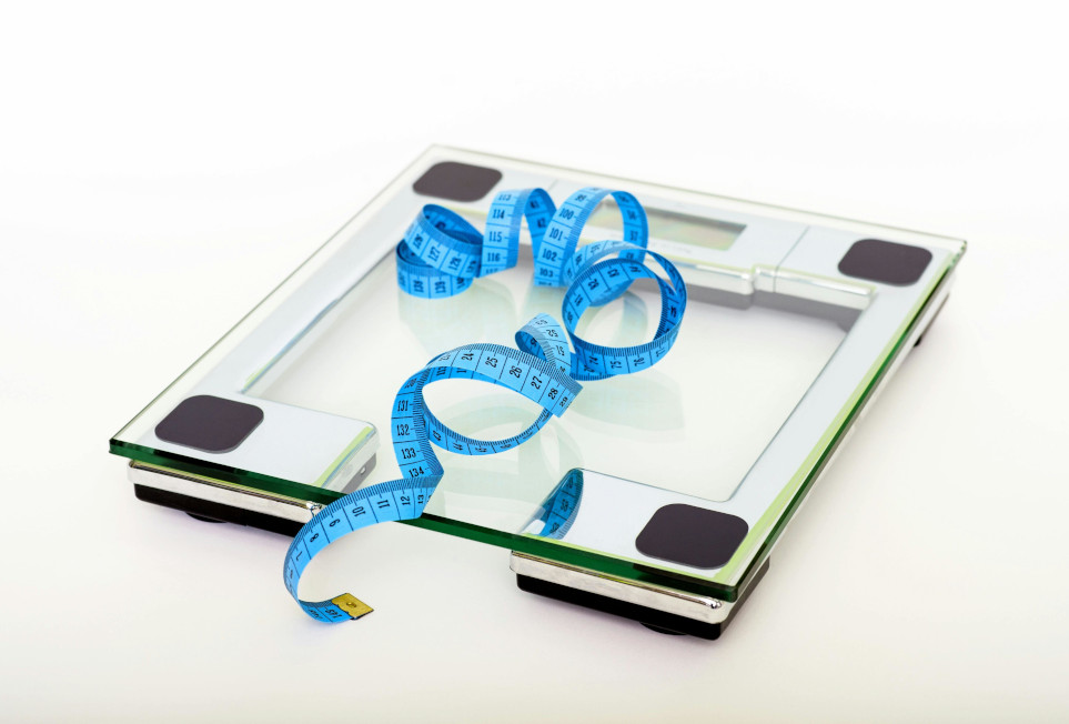A measuring tape on top of a scale